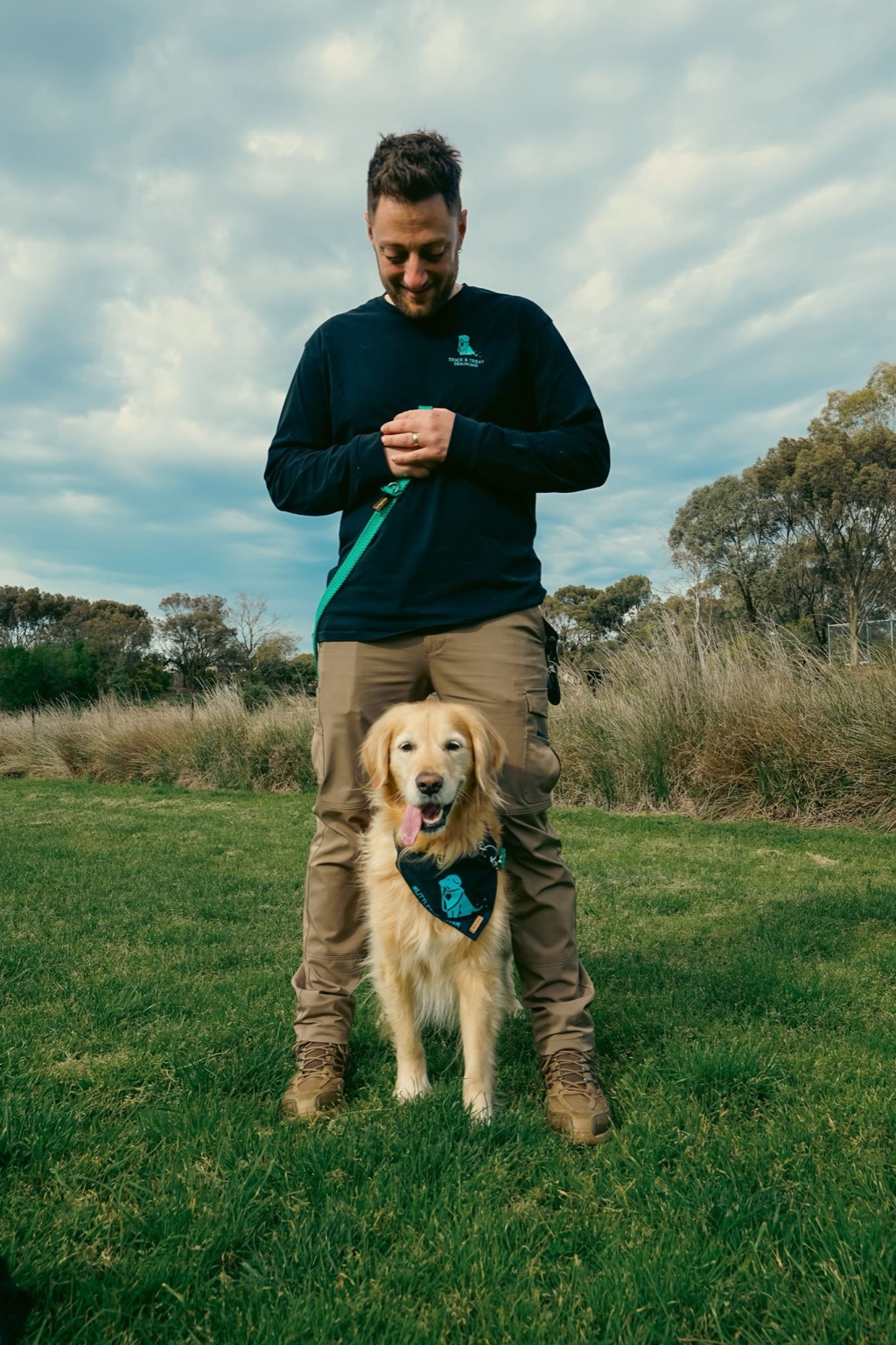 Ari with a Golden Retriever during dog training in Melbourne
